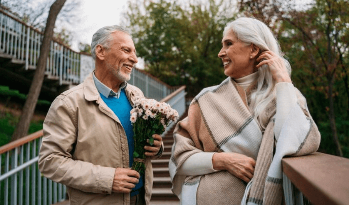 Elegant mature couple smiling during a walk together