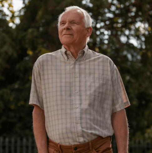 Senior man standing outdoors in a calm and natural setting