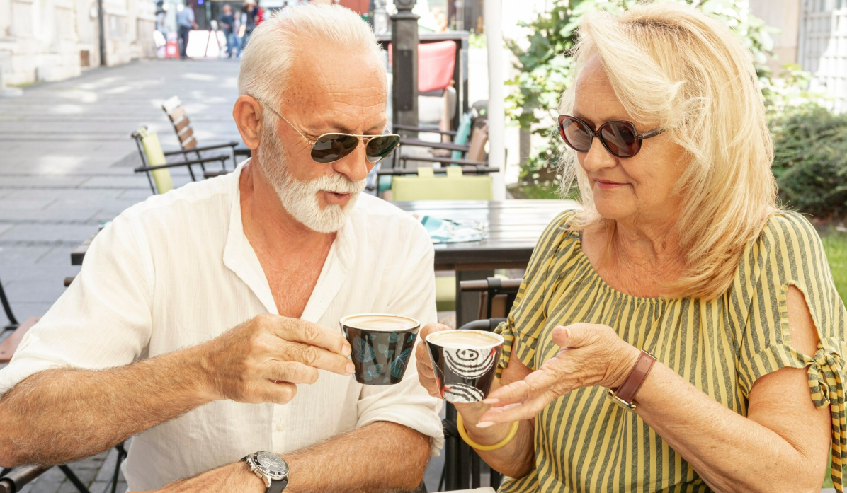Mature couple enjoying coffee together outdoors